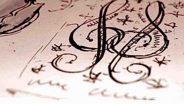 Two treble clef's are scribbled on a piece of paper. 