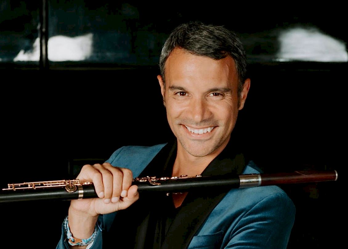 Portrait photo of Julien Beaudiment with a wooden flute