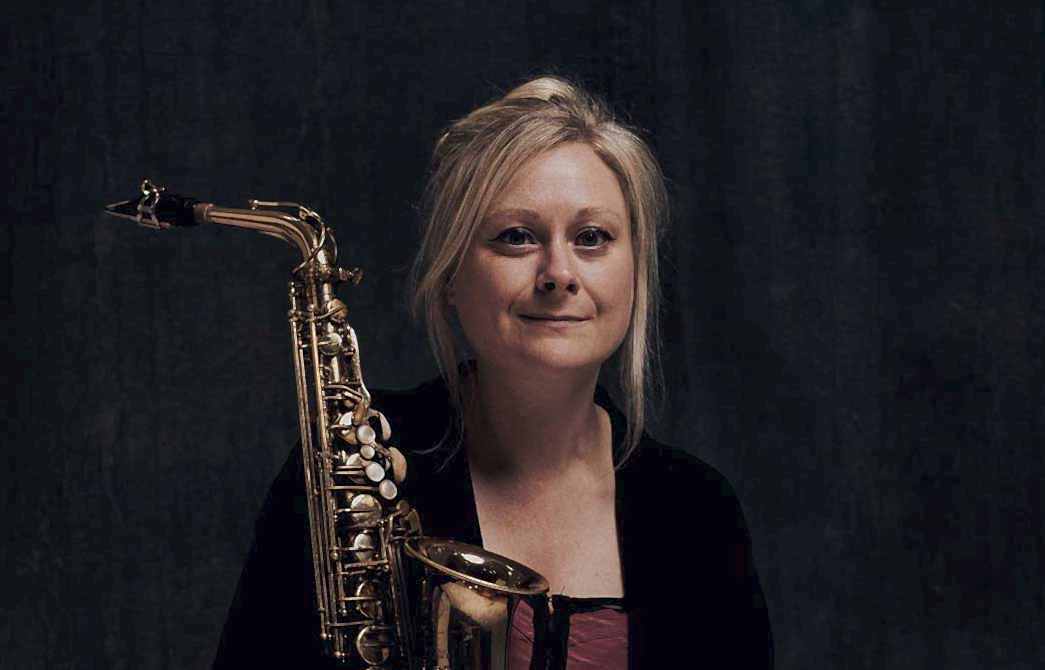 Portrait photo of Naomi Sullivan with an alto saxophone