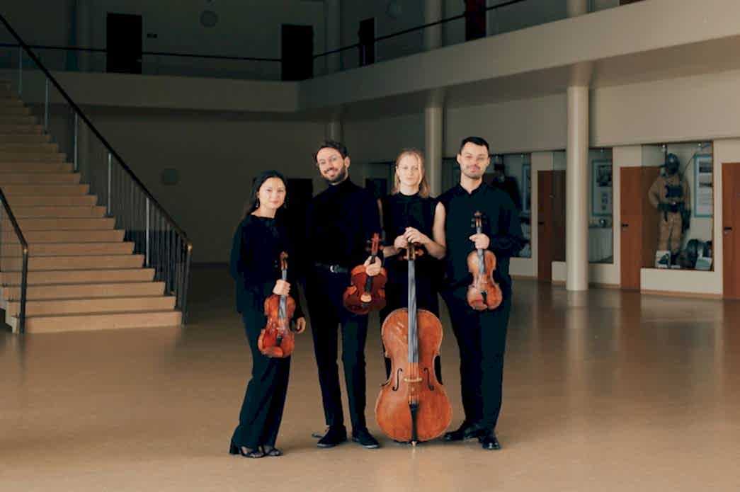 NOVO Quartet standing with instruments