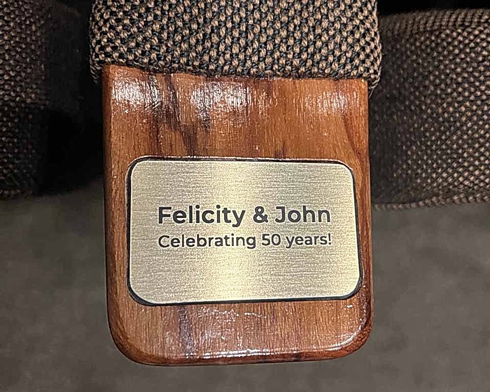 A seat plaque says Felicity and John Celebrating 50 years. 
