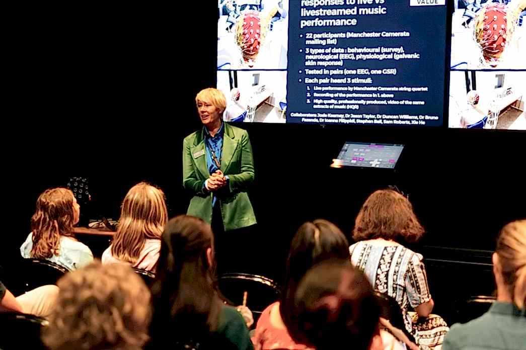 RNCM tutor talks to a group of people about research at the RNCM